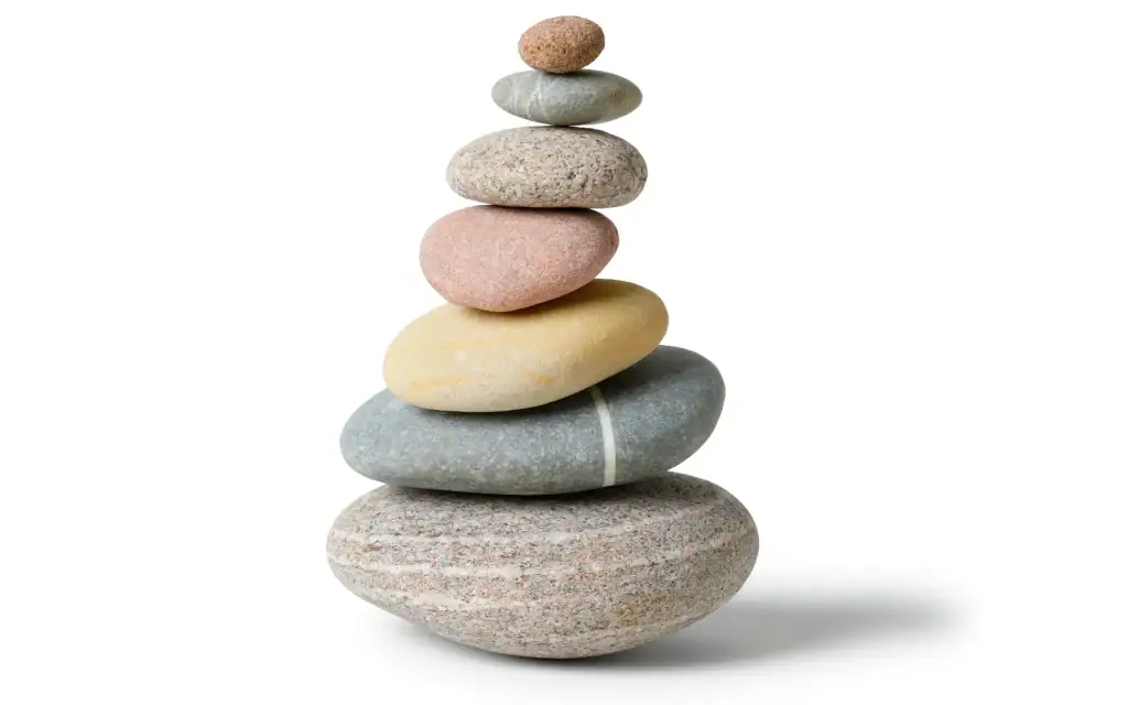 Smooth stacked stones arranged in a zen-inspired sculpture for relaxation and mindfulness.