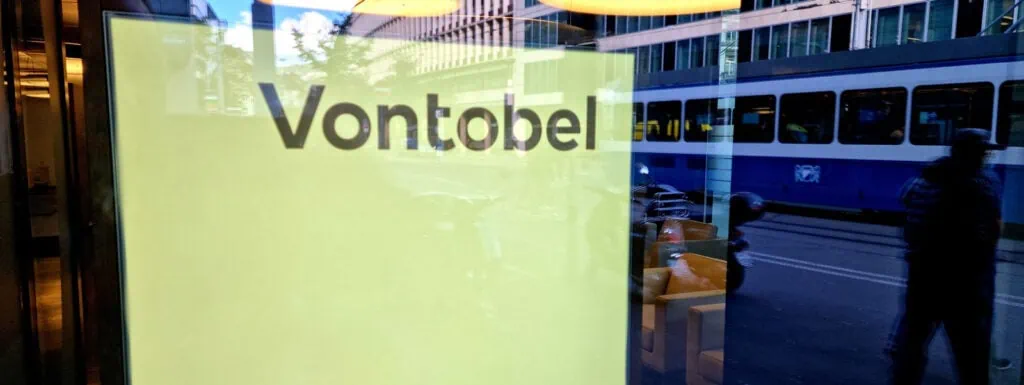 Innovative corporate office of Alpen Partners AG with reflective glass facade and city view.