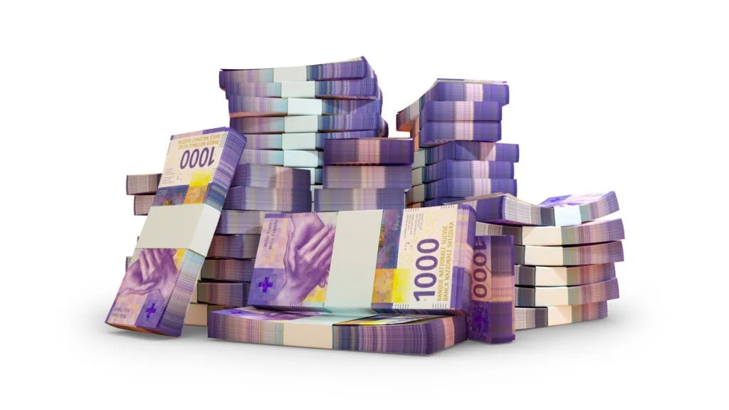 Stacks of Swiss 1000 franc banknotes arranged on a white background.