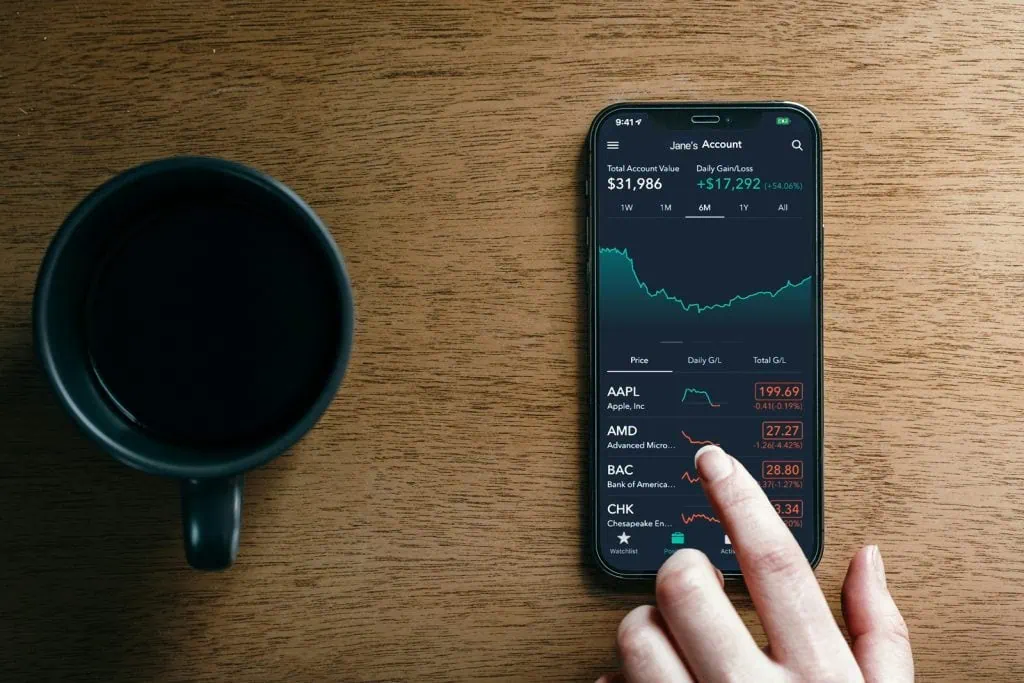 Financial trading app displaying stock market data on smartphone.
