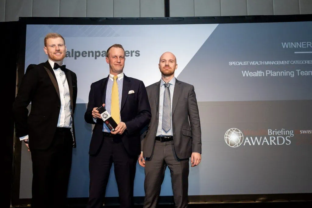 Professional team receiving Wealth Briefing Swiss Awards at Alpen Partners AG event.