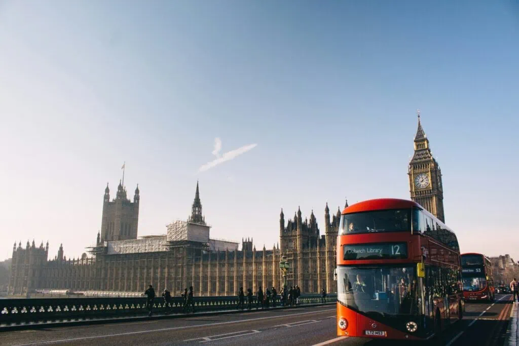Iconic London double-decker bus with Big Ben and the Houses of Parliament, UK.