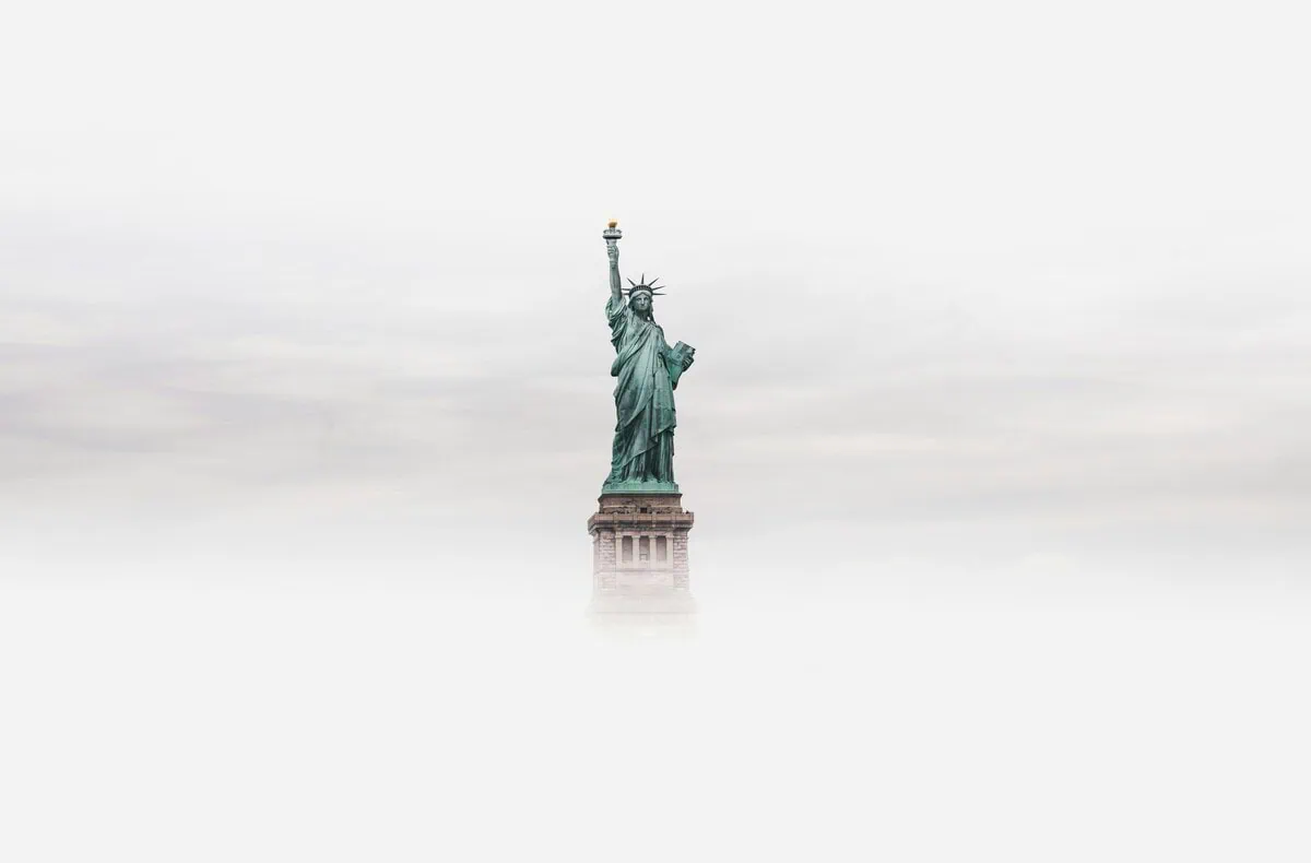 Statue of Liberty on a foggy sky background, symbol of freedom and New York City.