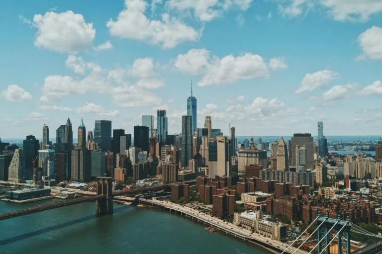 Modern New York City skyline with iconic skyscrapers and Brooklyn Bridge.