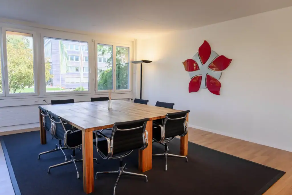 Bright modern office conference room with large windows and stylish décor.