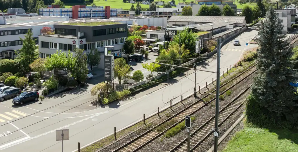 Modern commercial office complex near train tracks, Switzerland.