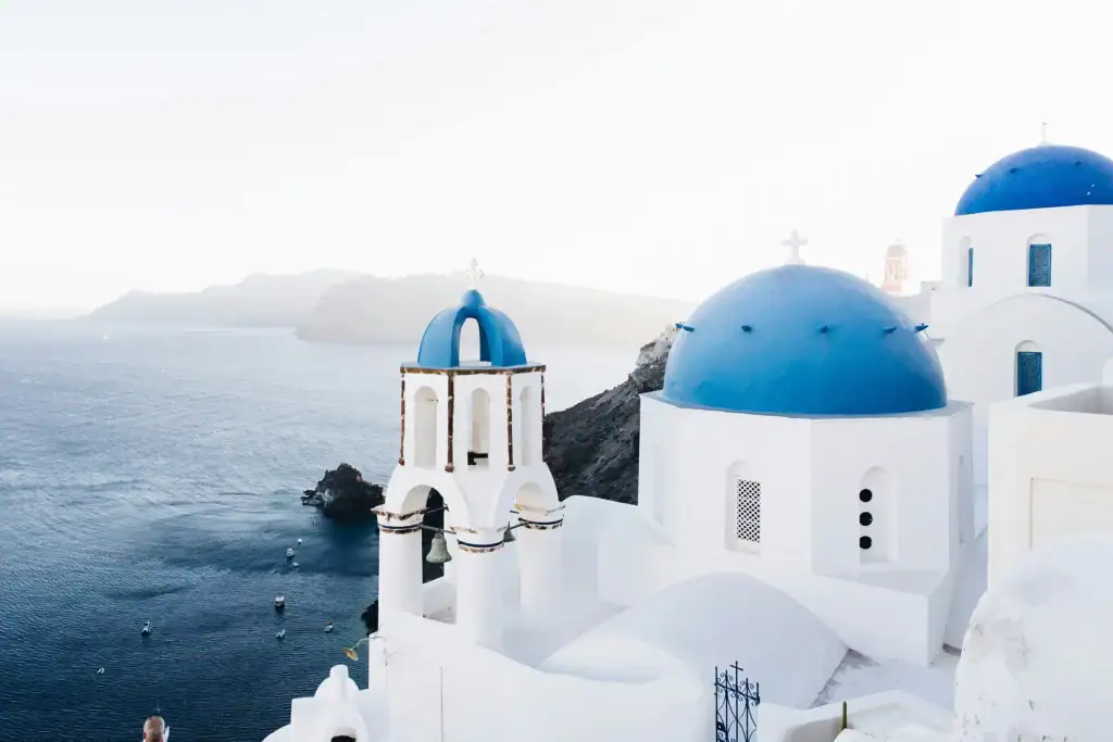 Blue-domed church in Santorini overlooking the Aegean Sea, Greece.