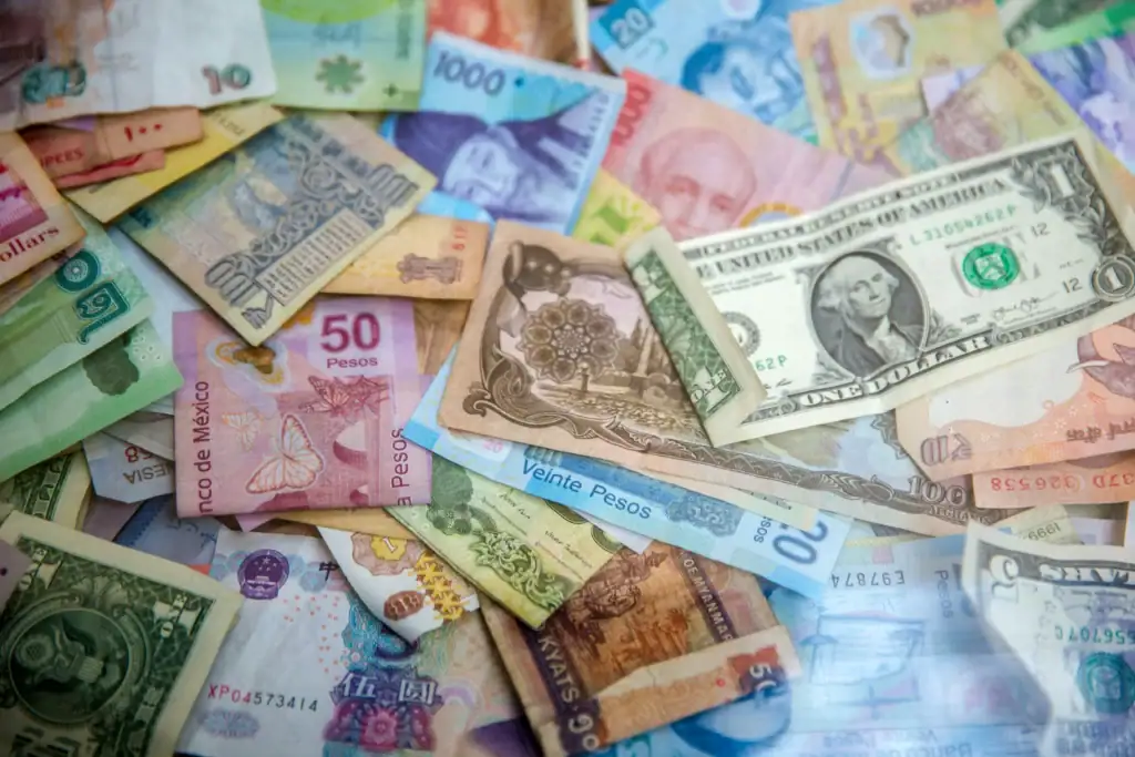 Various world banknotes and coins from different countries and currencies.
