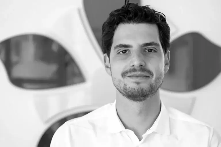 Portrait of a man in a white shirt at Alpen Partners office.