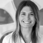 Smiling woman in professional setting at Alpen Partners AG.