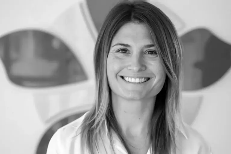 Smiling woman in professional setting at Alpen Partners AG.
