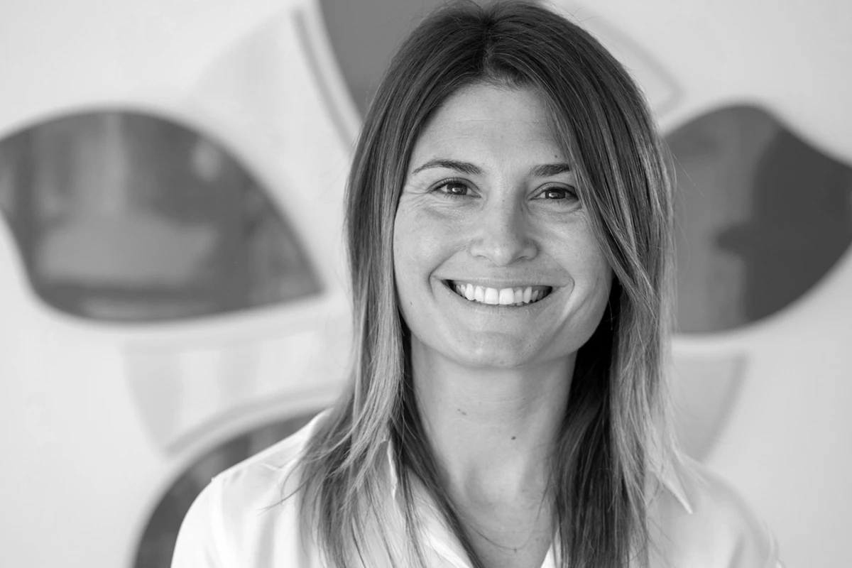 Smiling woman in professional setting at Alpen Partners AG.