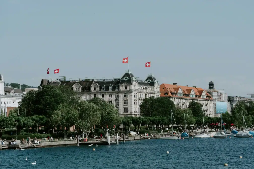 Swiss flags along a lakeside waterfront in a Swiss financial centre