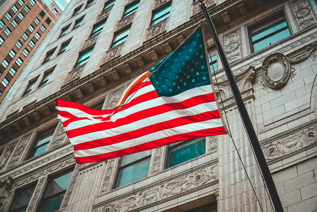 American flag flying outside a historic city building in the USA.